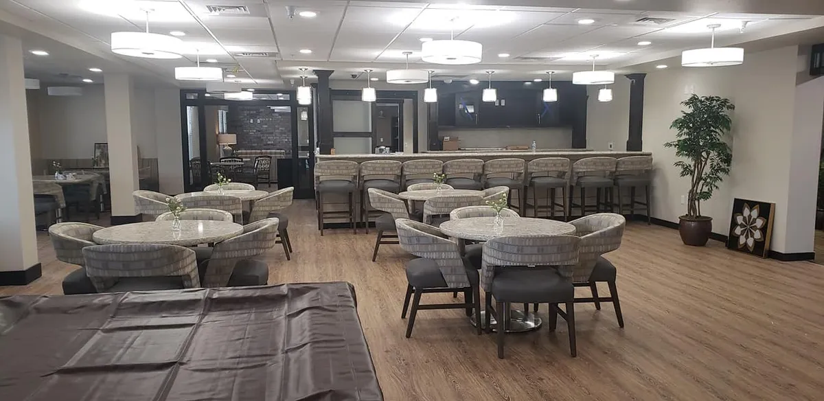 Bonaventure game room and bar area with round tables and upholstered chairs