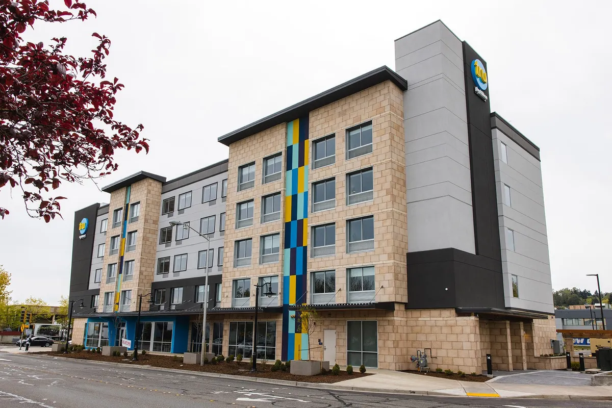 TRU by Hilton hotel exterior with blue and yellow accent panels