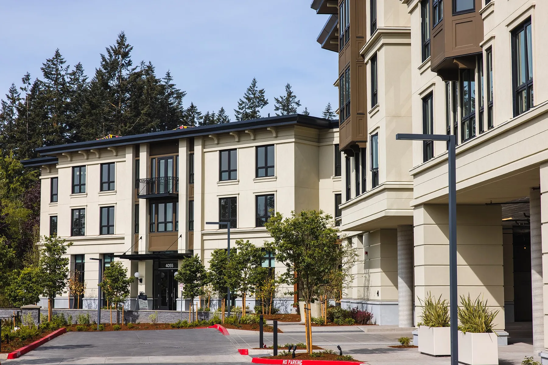 Lake Oswego Mercantile Village apartment buildings with young street trees