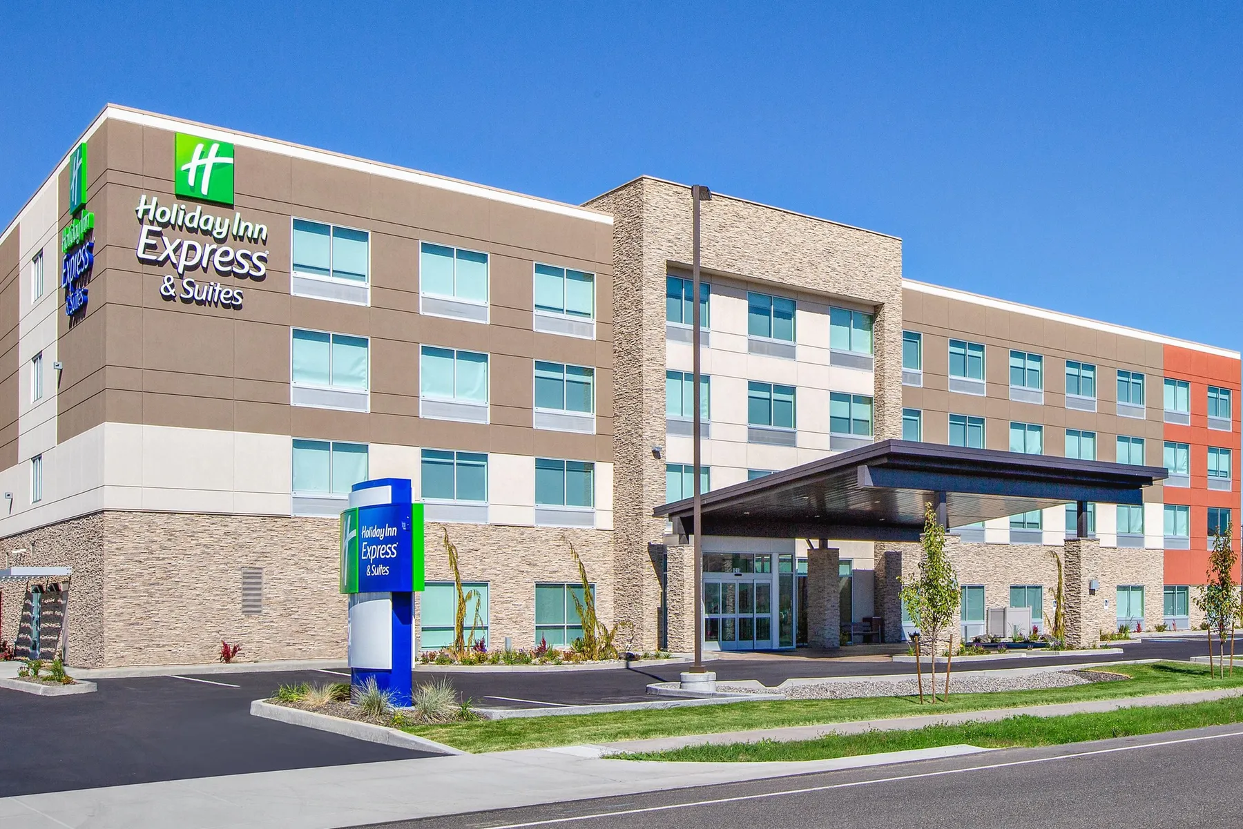 Holiday Inn Express & Suites four-story hotel exterior with its entrance canopy